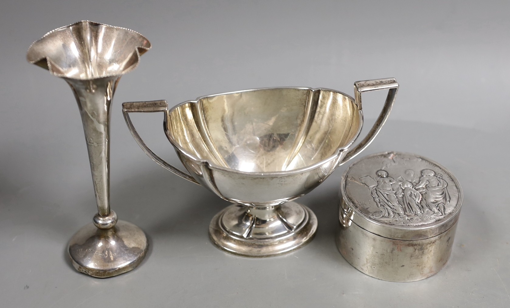 Miscellaneous silver ware including a mounted cigarette box, mounted posy vase, egg cup stand, late Victorian circular box and cover, repousse dish, eight sterling items including flatware and three other items.